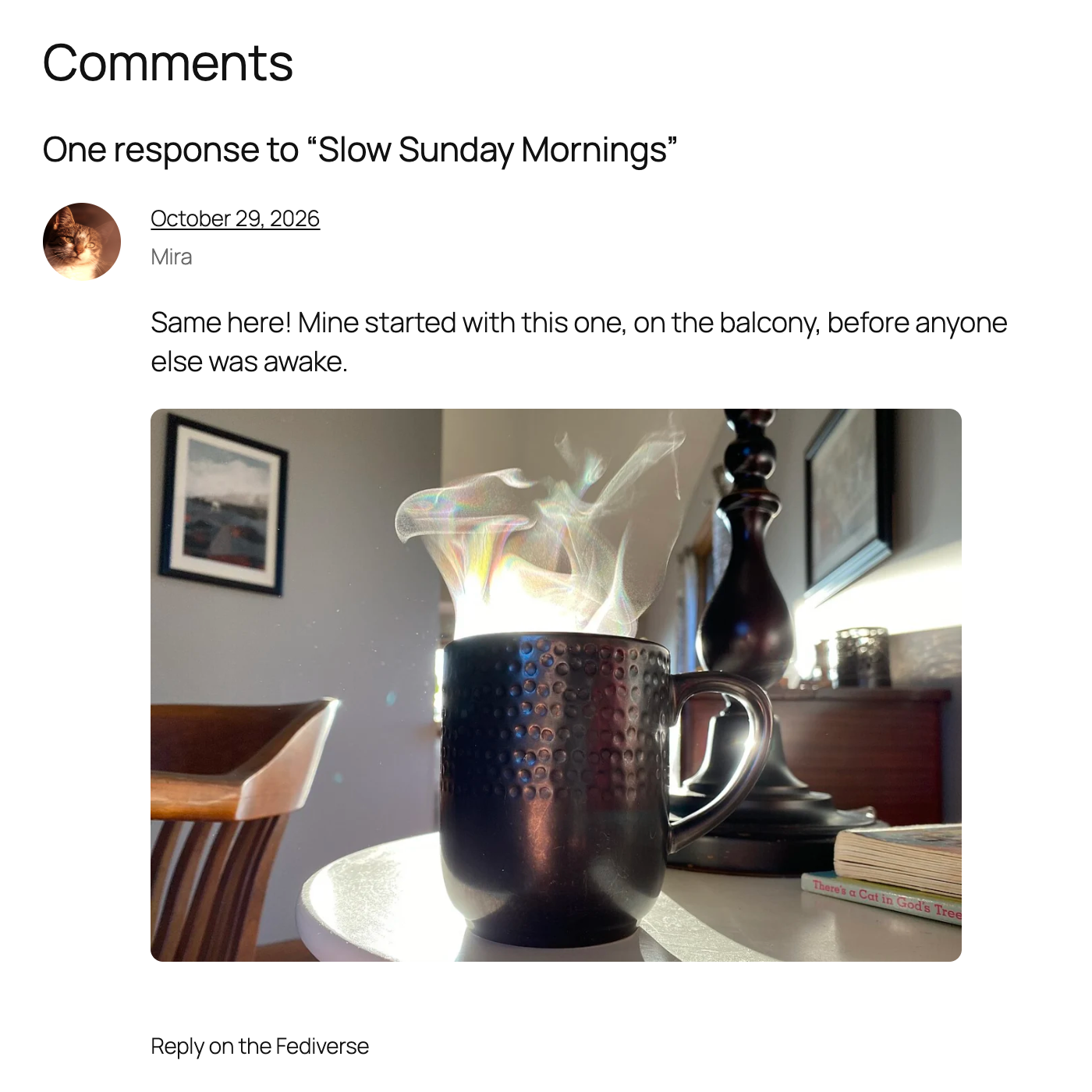 A Fediverse reply in the comment section, with the photo of a steaming coffee mug shown below the comment text.